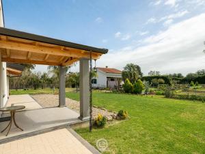 an outdoor patio with a table and a pavilion at Estay - Garden Paradise Escape - BBQ AirCon in Baratili San Pietro