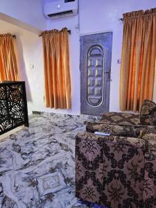 a room with a bed and two windows at Glory Apartment in Ibadan