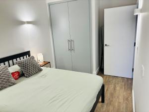 a bedroom with a bed and a closet at Your London Escape Luxurious 1 Bedroom Apartment in London