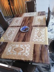 a wooden table with a plate of food on it at Glory Apartment in Ibadan