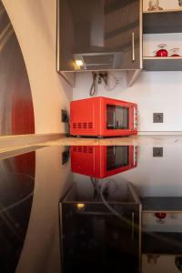 a red microwave sitting on top of a kitchen counter at Apartamento Rojo in Ateca +30 photos