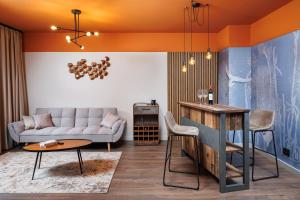 a living room with a couch and a table at Bucharest Comfort Suites Hotel in Bucharest