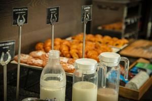 a counter with two bottles of milk and a tray of donuts at Hotel MC San José in San José