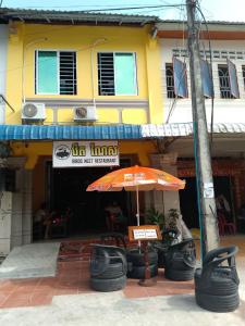 an orange umbrella in front of a restaurant at Birds Nest 2.0 in Kampot
