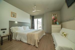 a large bedroom with two beds and a window at Hotel MC San José in San José