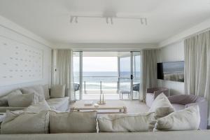 a living room with a couch and a view of the ocean at Cashelmara Beachfront Apartments in Gold Coast