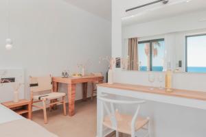 Plakakia Luxury Apartments في ماكري جيالوس: مطبخ وغرفة طعام مطلة على المحيط