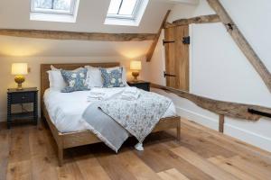 a bedroom with a bed and two night stands at Pass the Keys Merlin’s stables-country retreat in Brill