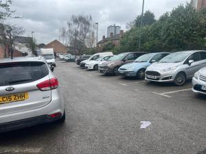 a row of parked cars in a parking lot at Studio Flat 7 With Private Shower & WC in Nottingham