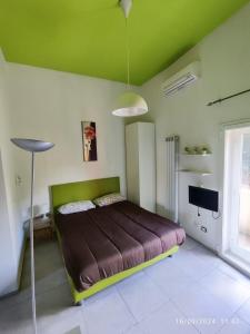 a bedroom with a large bed with a green ceiling at San Lollo Room in Rome