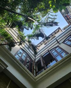 a house with a palm tree on top of it at La Maison de Bitasta in Puducherry