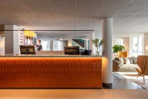 a lobby with a reception desk in a building at Comfort Hotel Park in Trondheim