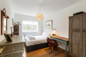 a bedroom with a bed and a desk and a desk at 2BR w park-view in S Newington in London