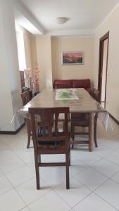 una mesa de madera y sillas en la sala de estar. en Casa Italia en Oratino