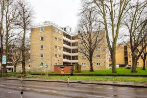 a large brick building on the side of a street at 2BR w park-view in S Newington in London