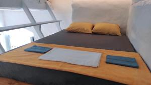 two beds in a small room with two pillows at Hidden Gem - Sifnos, Kastro. in Kástron