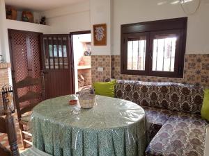 a living room with a table and a couch at Casa de la Fuente in Almonaster la Real