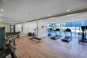 a gym with a lot of treadmills and exercise equipment at Burj Khalifa View With 5star Flatwalk Dubai Mall in Dubai