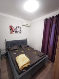 a bed in a room with purple curtains at High Hostel in Budva