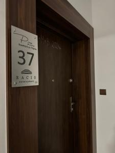 a sign on a door with a sign on it at Apartament Pileckiego 7b/37 in Suwałki +3 photos