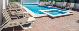 a swimming pool with lounge chairs and a swimming pool at Dineta Flat Apartment in Ulcinj