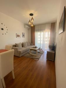 a living room with a couch and a table at Dineta Flat Apartment in Ulcinj