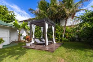 a wooden gazebo in the yard of a house at Ingleses Praia Hotel - Com Piscina Aquecida in Florianópolis