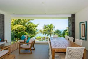 a dining room with a table and a view of the ocean at Seafront apt breathtaking view in Cap Malheureux in Cap Malheureux