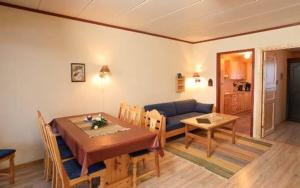 a living room with a table and a blue couch at Skarslia Apartment in Skarsgård