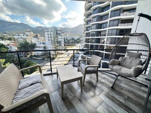 a balcony with swings and chairs on a building at 2+1 Girne CC Towers in Kyrenia