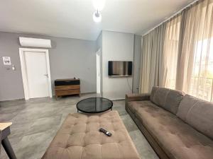 a living room with a couch and a table at 2+1 Girne CC Towers in Kyrenia