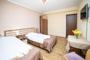 a hospital room with two beds and a tv at Guest House Kavkasioni 33 in Telavi