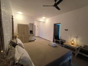 a bedroom with a bed and a living room at Sea View Apartments , Mandrem Beach in Mandrem