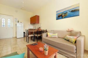 a living room with a couch and a table at Ziros Apts Xerokampos in Xerokampos