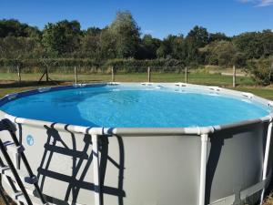 a large pool with a chair around it at CHAMBRE ROMANTIQUE in Mur-de-Sologne