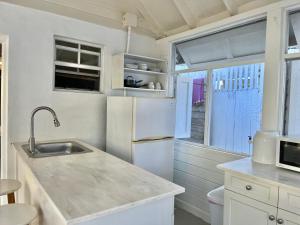 a kitchen with a sink and a refrigerator at Downtown Nassau Oasis Unit 3 in Nassau