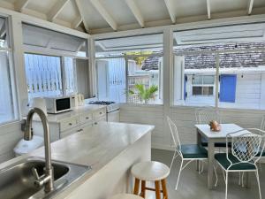 a kitchen with a sink and a table with chairs at Downtown Nassau Oasis Unit 3 in Nassau