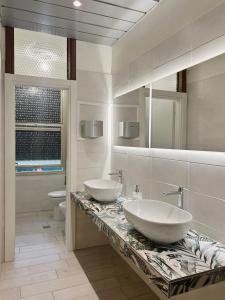 two sinks on a marble counter in a bathroom at Hotel Concorde in Bellaria-Igea Marina