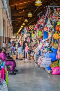 a group of people standing in a store with bags at Downtown Nassau Oasis Unit 3 in Nassau