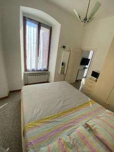 a bedroom with a large bed and a window at La casa di Raffa in Bonassola