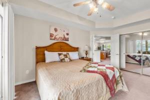 a bedroom with a large bed and a ceiling fan at Branson Condo at Thousand Hills Walkin with Elevator Golf Front and close to 76 in Branson
