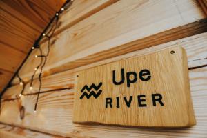 a sign that saysupper river hanging on a wall at Labieši in Jūrmala