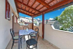 a patio with a table and chairs on a balcony at Apartments Medulin 2315 in Medulin