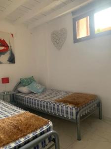 a bedroom with two beds and a heart on the wall at Laokoontos 16 in Rhodes Town +16 photos