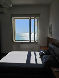 a bedroom with a bed and a large window at Maison Silvana, Luxury Apartment in Salerno