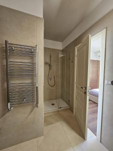 a bathroom with a shower and a glass door at Maison Silvana, Luxury Apartment in Salerno