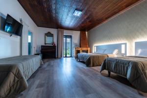 a bedroom with two beds and a wooden ceiling at Alta Dimora in Bitritto