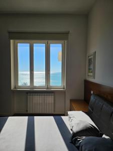 a bedroom with a bed and a large window at Maison Silvana, Luxury Apartment in Salerno