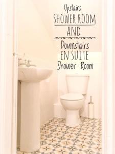 a bathroom with a toilet and a sink at Moville Beach Townhouse on Wild Atlantic Way in Moville +13 photos