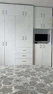 cocina con armarios blancos y encimera en Harmony Luisa Apartment #Enjoy#Otopeni# en Otopeni
